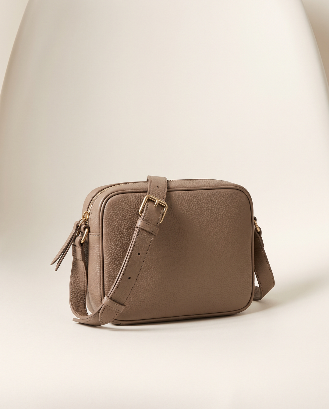 The Liberty Village Crossbody in taupe pebbled vegan leather with brushed gold hardware