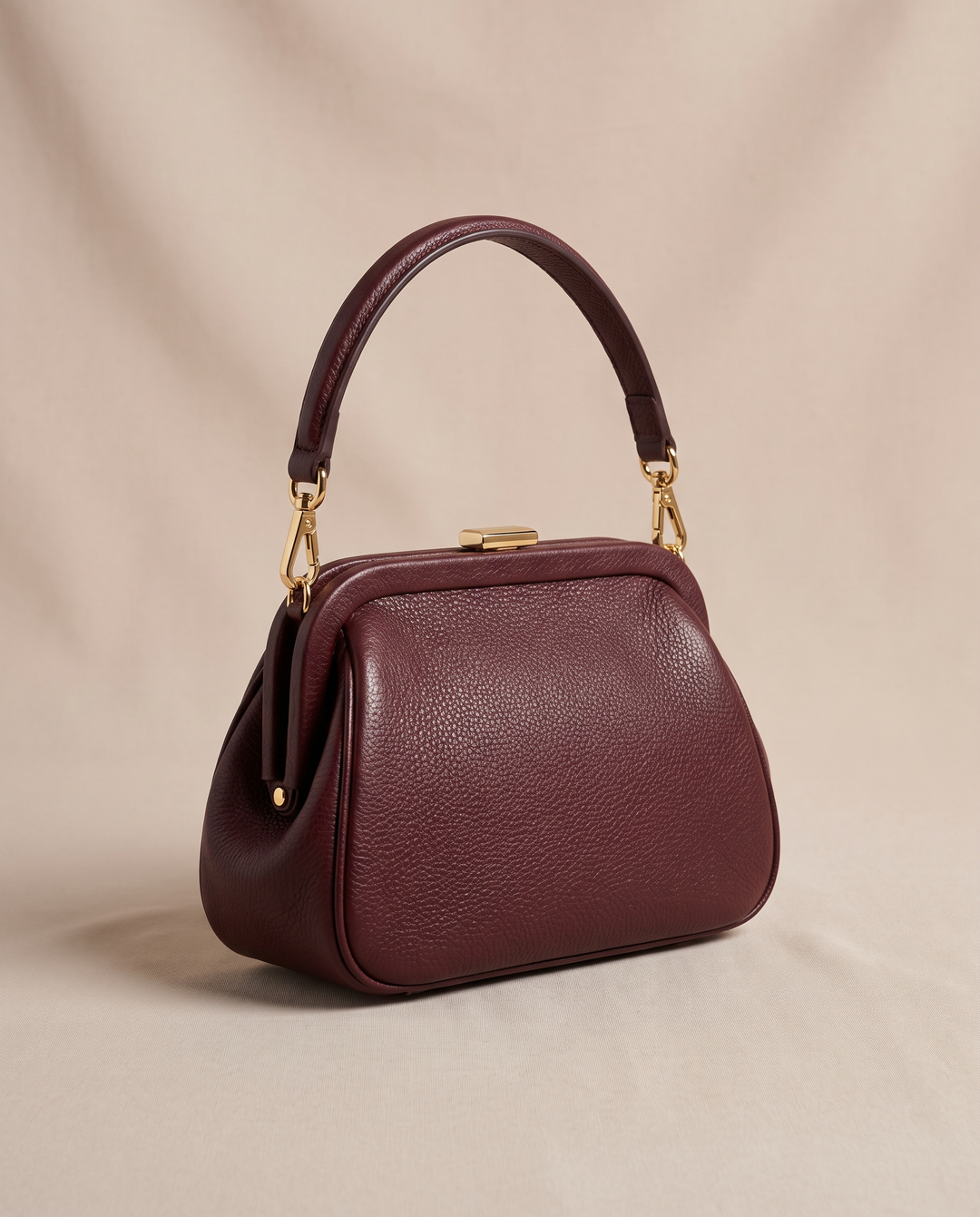 The Riverdale Mini in deep burgundy pebbled vegan leather with polished gold-tone hardware